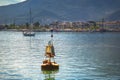 Solar-powered buoy marks the navigable fairway in the harbor Royalty Free Stock Photo