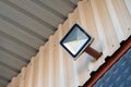 Solar powered led spotlight mounted on the outer wall of the warehouse Royalty Free Stock Photo