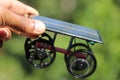 Solar powered working model car held in hand with 3D printed wheels and a natural background Royalty Free Stock Photo