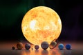 Solar System Scale Concept Of Planets And Sun. Glowing Star With Planetary Spheres Aligned In Front View With Dramatic Lighting. Royalty Free Stock Photo