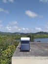 Solar thermal panel on roof of Caribbean house in tropical nature landscape and blue sky. Caribbean roof with solar panel; system