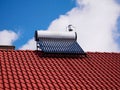 Solar water heater boiler on rooftop, blue sky with white clouds Royalty Free Stock Photo