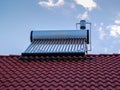 Solar water heater boiler on rooftop at early cold June morning