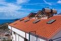 Solar water heater installed on tile roof of house for environmentally friendly heating of water. Large water tanks. Horizontal Royalty Free Stock Photo