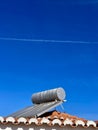 Solar water heater installed on tile roof of house for environmentally Royalty Free Stock Photo