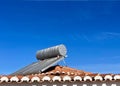 Solar water heater installed on tile roof of house for environmentally Royalty Free Stock Photo