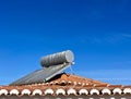 Solar water heater installed on tile roof of house for environmentally Royalty Free Stock Photo