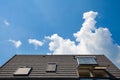 Solar water panel with dormers on a roof against blue sky. Royalty Free Stock Photo