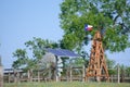 Solar Water well with Texas Windmill in front of summer green trees, farm ranch fence and blue sky background