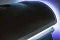 Solarium - tanning bed with a closed lid and a very beautiful purple-blue alluring lighting