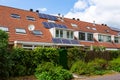 Solarpannels on the orange tiled roof of a terraced house with a dormer in the South-Holland village of Sassenheim