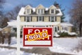 Sold Home For Sale Real Estate Sign in Front of New Snow Covered House Royalty Free Stock Photo