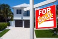 Sold Home For Sale Sign in Front of New House. Royalty Free Stock Photo