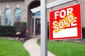 Sold Home For Sale Sign in Front of New House. Royalty Free Stock Photo