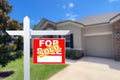 Sold Home For Sale Sign in Front of New House. Royalty Free Stock Photo