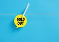 Sold out message on a speech bubble hanging on clothesline with a clothespin. Business sales concept Royalty Free Stock Photo