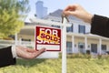 Sold Sign and Agent Handing Over Keys to New Home Royalty Free Stock Photo