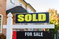 Sold sign against a house in a residential neighborhood Royalty Free Stock Photo