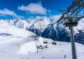 SOLDEN, AUSTRIA - 9 MARCH 2016: Skiers and double chairlift in Alpine ski resort in Solden Royalty Free Stock Photo