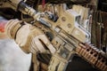 Solder in gloves holding assault automatic rifle Royalty Free Stock Photo
