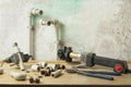 Soldering iron for plastic pipes on wooden table on old wall background. Royalty Free Stock Photo