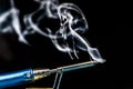 soldering iron with smoke on a black background. Electrical
