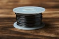 Soldering iron and solder wire on wooden table background