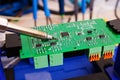 Soldering process on a green PCB closeup Royalty Free Stock Photo
