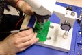 Soldering process on a green PCB closeup