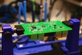 Soldering process on a green PCB closeup Royalty Free Stock Photo