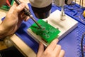 Soldering process on a green PCB closeup Royalty Free Stock Photo