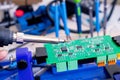 Soldering process on a green PCB closeup