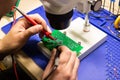 Soldering process on a green PCB closeup Royalty Free Stock Photo