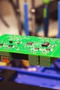 Soldering process on a green PCB closeup Royalty Free Stock Photo