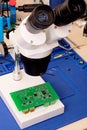 Soldering process on a green PCB closeup Royalty Free Stock Photo