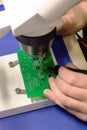 Soldering process on a green PCB closeup Royalty Free Stock Photo