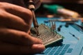 Soldering process, hot soldering iron and breadboard Royalty Free Stock Photo