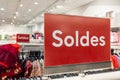 Soldes french text means red sale sign on shop shelf in clothing store