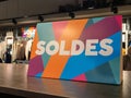 Soldes french text means sale sign on shop shelf in clothing store on rack rack Royalty Free Stock Photo