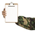 Soldier arm holding a white file of paper with space to text