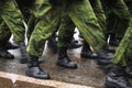 Soldier boots walking on wet asphalt during the parade of memory. The military marching down the street. Many shoes and Royalty Free Stock Photo