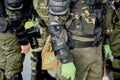 A soldier with a camera stands among the soldiers in the rain