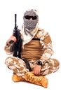 Soldier in camouflage and arabian scarf holding a rifle