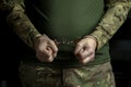 A soldier in camouflage, hands of a military man in handcuffs. Royalty Free Stock Photo