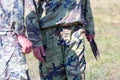 Soldier in camouflage holding throwing knives