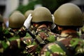 Soldier in camouflage uniform arranging his helmet