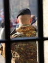 soldier with camouflage uniform outside a prison