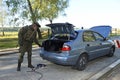Soldier conducting a search of a stopped car. Checkpoint, training. Novo-Petrivtsi military base, Ukraine