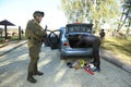 Soldier conducting a search of a stopped car. Checkpoint, training. Novo-Petrivtsi military base, Ukraine