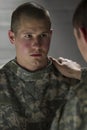 Soldier consoles peer with PTSD, vertical